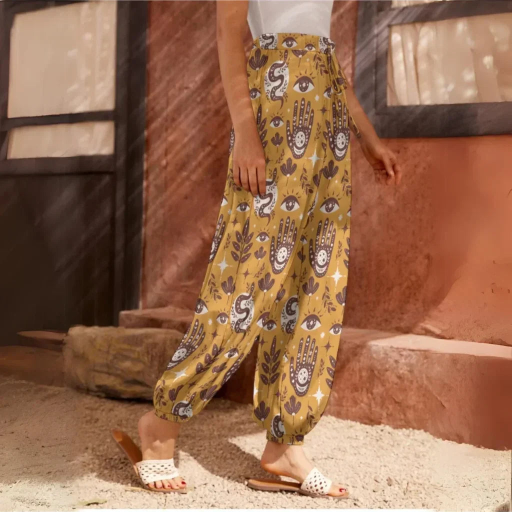 Yellow patterned harem pants with hamsa and floral motifs, side view - RETRO MYSTIC HAREM PANTS WOMEN FOR YOGA & COMFORT