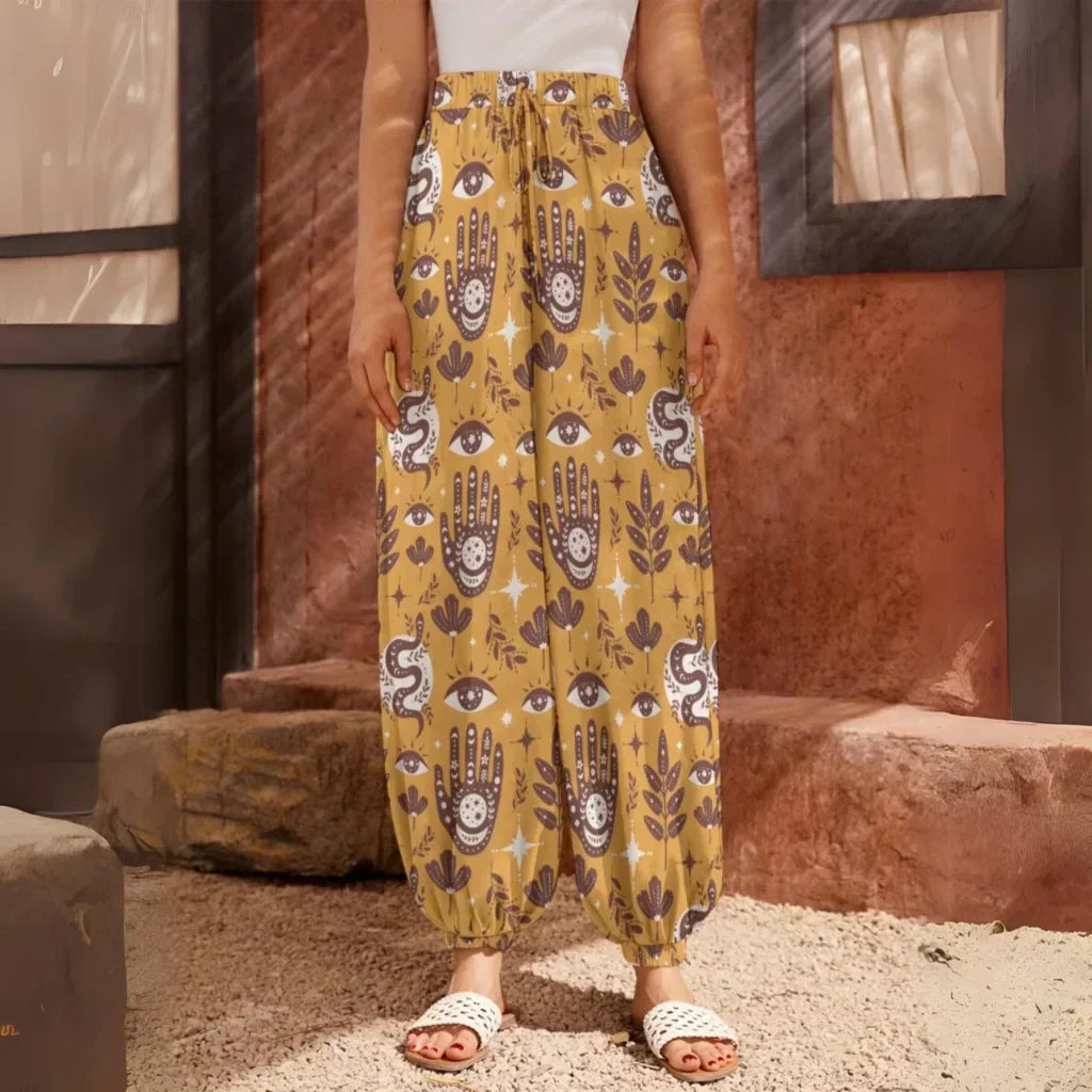 Yellow patterned harem pants with hamsa and floral motifs, front view - RETRO MYSTIC HAREM PANTS WOMEN FOR YOGA & COMFORT