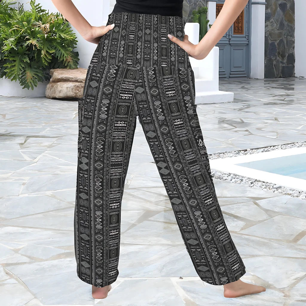 Wide-leg pants featuring a black and white tribal geometric print pattern, back view - BOHO ETHNIC ALADDIN PANTS FOR LADIES FOR YOGA & CASUAL WEAR