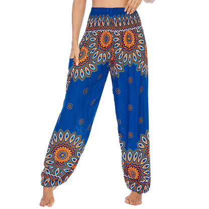 Colorful bohemian-style harem pants with peacock feather and geometric patterns, blue colored, front view - BOHO SMOCKED ALADDIN PANTS FOR LADIES