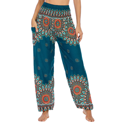 Colorful bohemian-style harem pants with peacock feather and geometric patterns, teal colored, front view - BOHO SMOCKED ALADDIN PANTS FOR LADIES