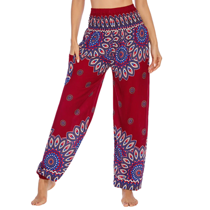 Colorful bohemian-style harem pants with peacock feather and geometric patterns, red colored, front view - BOHO SMOCKED ALADDIN PANTS FOR LADIES