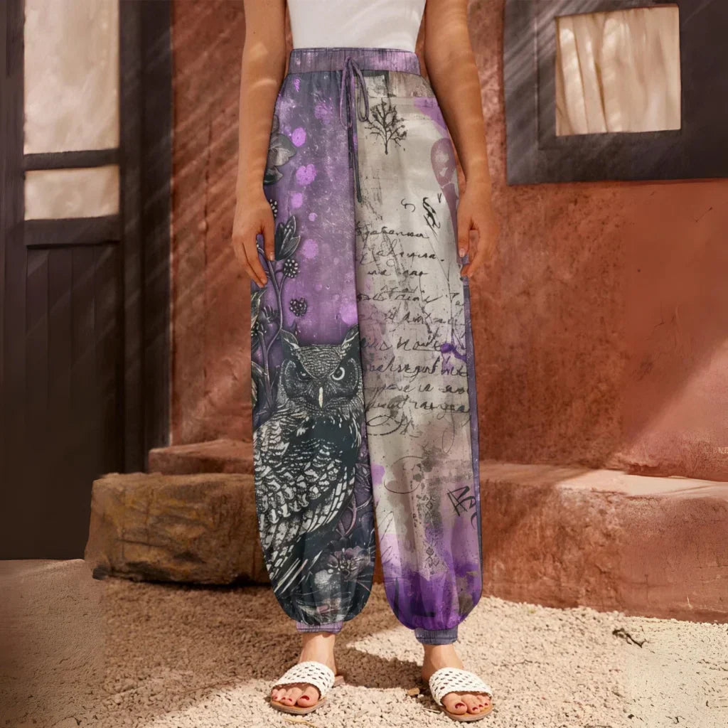 Loose-fitting harem pants with an owl and text print design in purple and gray tones, front view - ENCHANTED OWL HAREM PANTS WOMEN