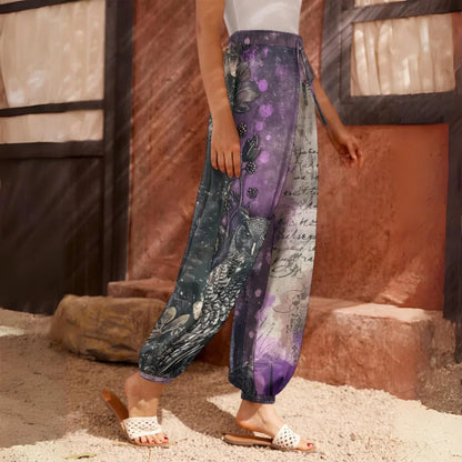 Loose-fitting harem pants with an owl and text print design in purple and gray tones, side view - ENCHANTED OWL HAREM PANTS WOMEN