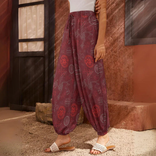 Burgundy harem pants with floral print pattern and elastic cuffs at the ankles, side view - MYSTIC DRAGON SKELETON HAREM PANTS WOMEN