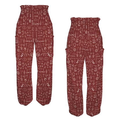 Burgundy-colored loose pants with white doodle-style pattern print, fromt-back view - MYSTIC NUMBERS HIGH-WAISTED ALADDIN PANTS FOR LADIES