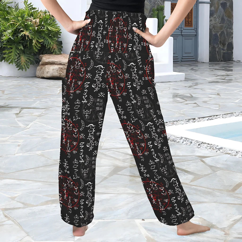 Flowy black harem pants with red and white geometric tribal print pattern, back view - MYSTIC RED ALCHEMY ALADDIN PANTS FOR LADIES