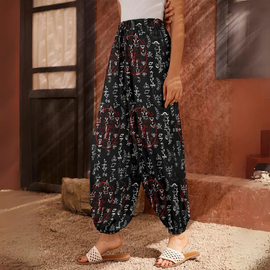 Black harem pants with white geometric pattern print, side view - MYSTICAL ALCHEMY HAREM PANTS WOMEN