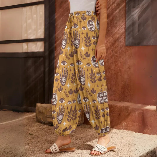 Yellow patterned harem pants with hamsa and floral motifs, side view - RETRO MYSTIC HAREM PANTS WOMEN FOR YOGA & COMFORT