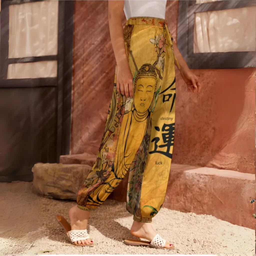 Yellow harem pants featuring Buddha artwork and Chinese characters, side view - SACRED SAKURA BLOSSOMS HAREM PANTS WOMEN