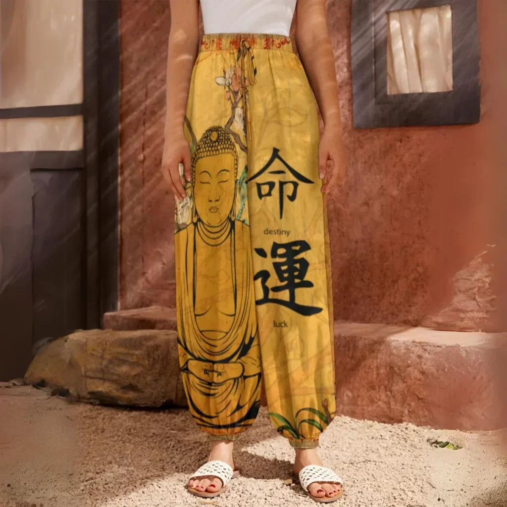 Yellow harem pants featuring Buddha artwork and Chinese characters, front view - SACRED SAKURA BLOSSOMS HAREM PANTS WOMEN