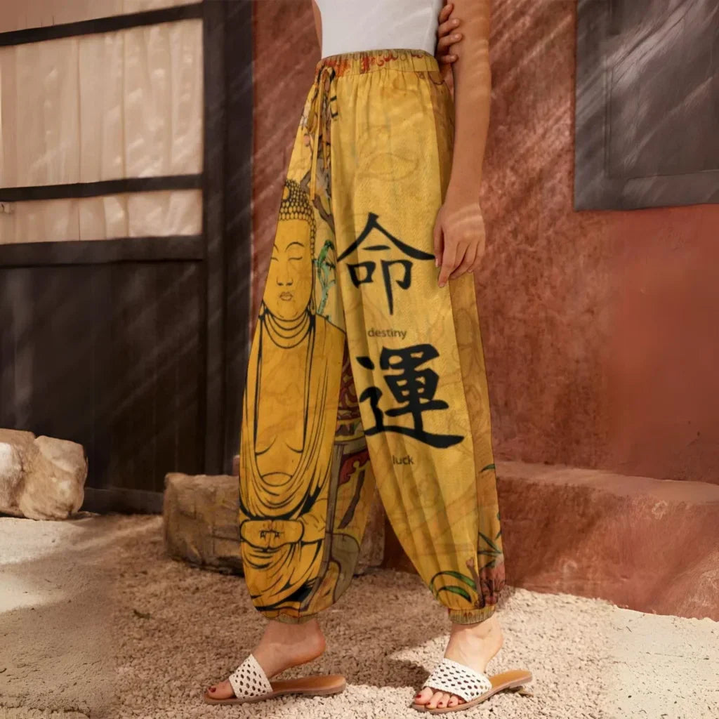 Yellow harem pants featuring Buddha artwork and Chinese characters, side view - SACRED SAKURA BLOSSOMS HAREM PANTS WOMEN