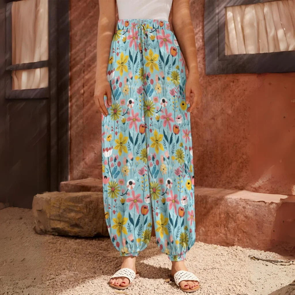 Light blue floral harem pants with an elastic waistband and ankle cuffs, front view - SEAMLESS DOODLE FLORAL HAREM PANTS WOMEN