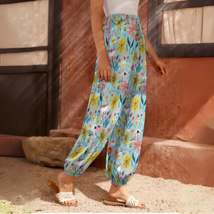 Light blue floral harem pants with an elastic waistband and ankle cuffs, side view - SEAMLESS DOODLE FLORAL HAREM PANTS WOMEN