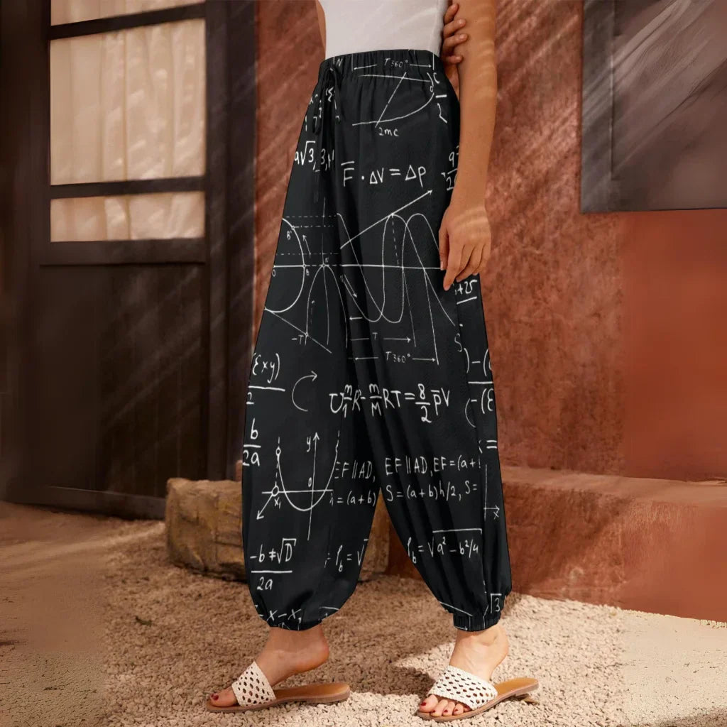 Black pants with white mathematical equations and formulas printed all over them, side view - SEAMLESS MATH FORMULA HAREM PANTS WOMEN WITH DIVINE DESIGN