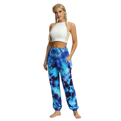 Vibrant tie-dye blue harem pants with elastic cuffs paired with a white crop top, front view - TIE DYE SMOCKED ALADDIN PANTS FOR LADIES FOR YOGA & FESTIVALS - Style A / Average Size