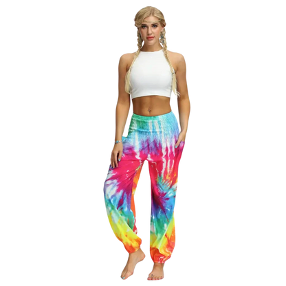 Vibrant tie-dye yellow harem pants with elastic cuffs paired with a white crop top, front view - TIE DYE SMOCKED ALADDIN PANTS FOR LADIES FOR YOGA & FESTIVALS - Style A / Average Size