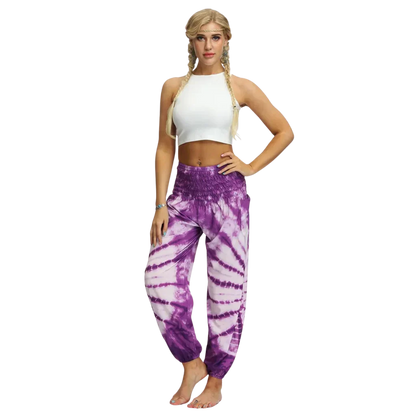 Vibrant tie-dye purple-white harem pants with elastic cuffs paired with a white crop top, front view - TIE DYE SMOCKED ALADDIN PANTS FOR LADIES FOR YOGA & FESTIVALS - Style A / Average Size