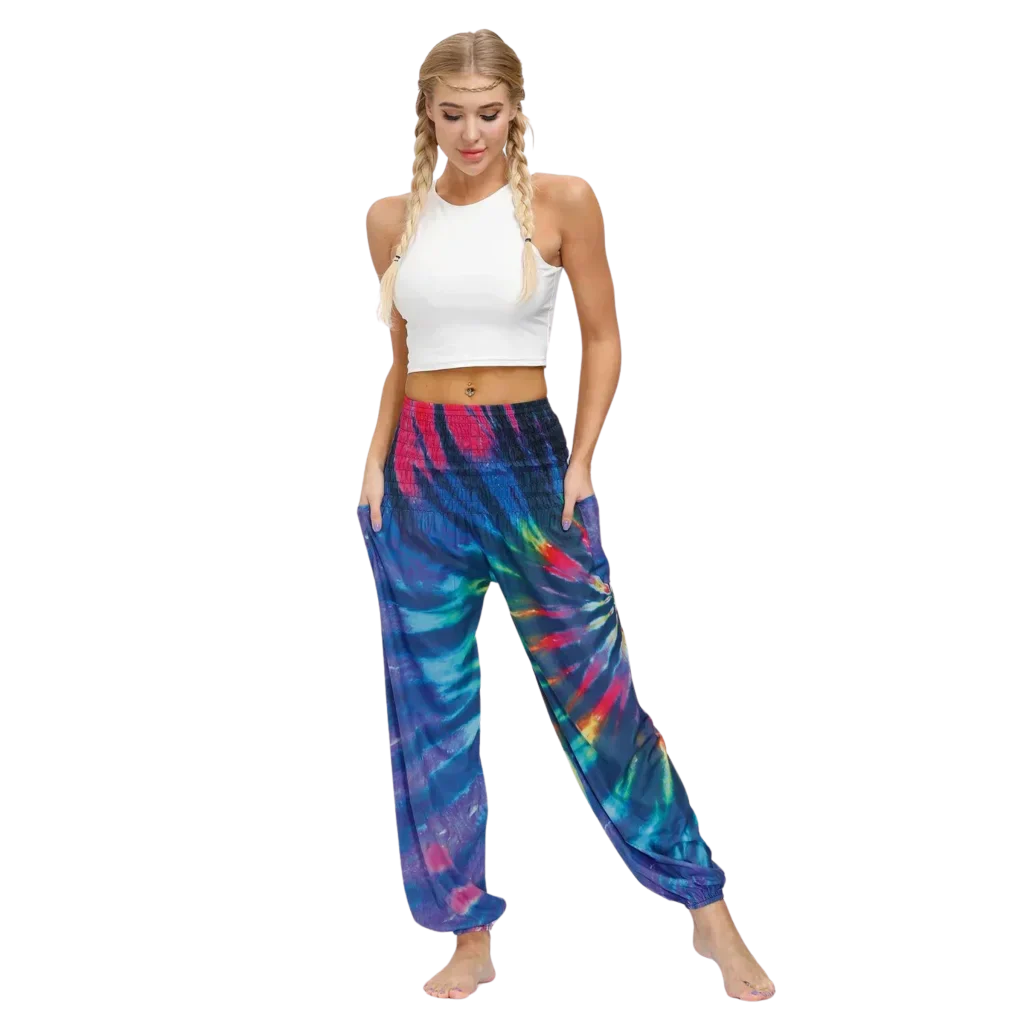 Vibrant tie-dye purple-pink harem pants with elastic cuffs paired with a white crop top, front view - TIE DYE SMOCKED ALADDIN PANTS FOR LADIES FOR YOGA & FESTIVALS - Style A / Average Size