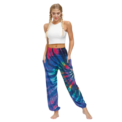 Vibrant tie-dye purple-pink harem pants with elastic cuffs paired with a white crop top, front view - TIE DYE SMOCKED ALADDIN PANTS FOR LADIES FOR YOGA & FESTIVALS - Style A / Average Size