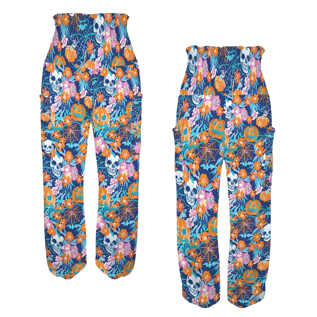 Colorful floral and skull print harem pants with an elastic waistband, front-back view - VIBRANT HALLOWEEN SMOCKED ALADDIN PANTS FOR LADIES