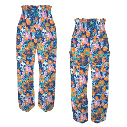 Colorful floral and skull print harem pants with an elastic waistband, front-back view - VIBRANT HALLOWEEN SMOCKED ALADDIN PANTS FOR LADIES